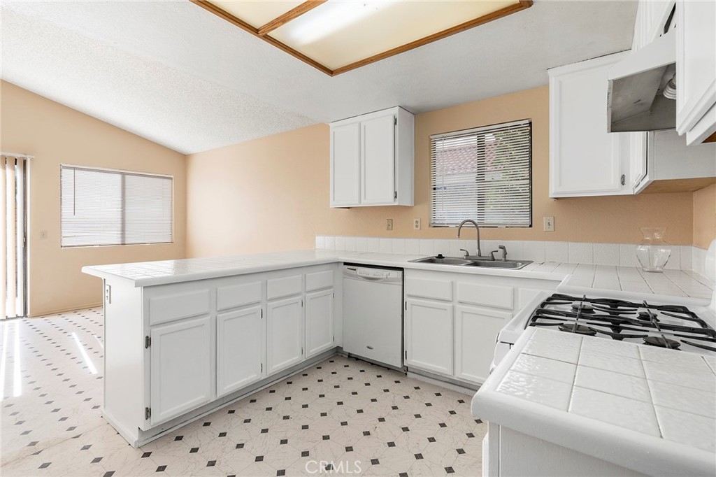 3665 Anchorage Street Hemet, CA 92545 - Photo 7 of 23 a kitchen with a sink a stove cabinets and a window