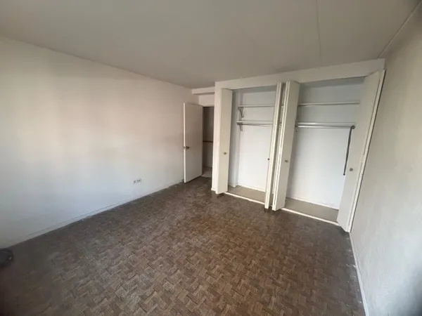 a view of a balcony with a floor to ceiling window and wooden floor
