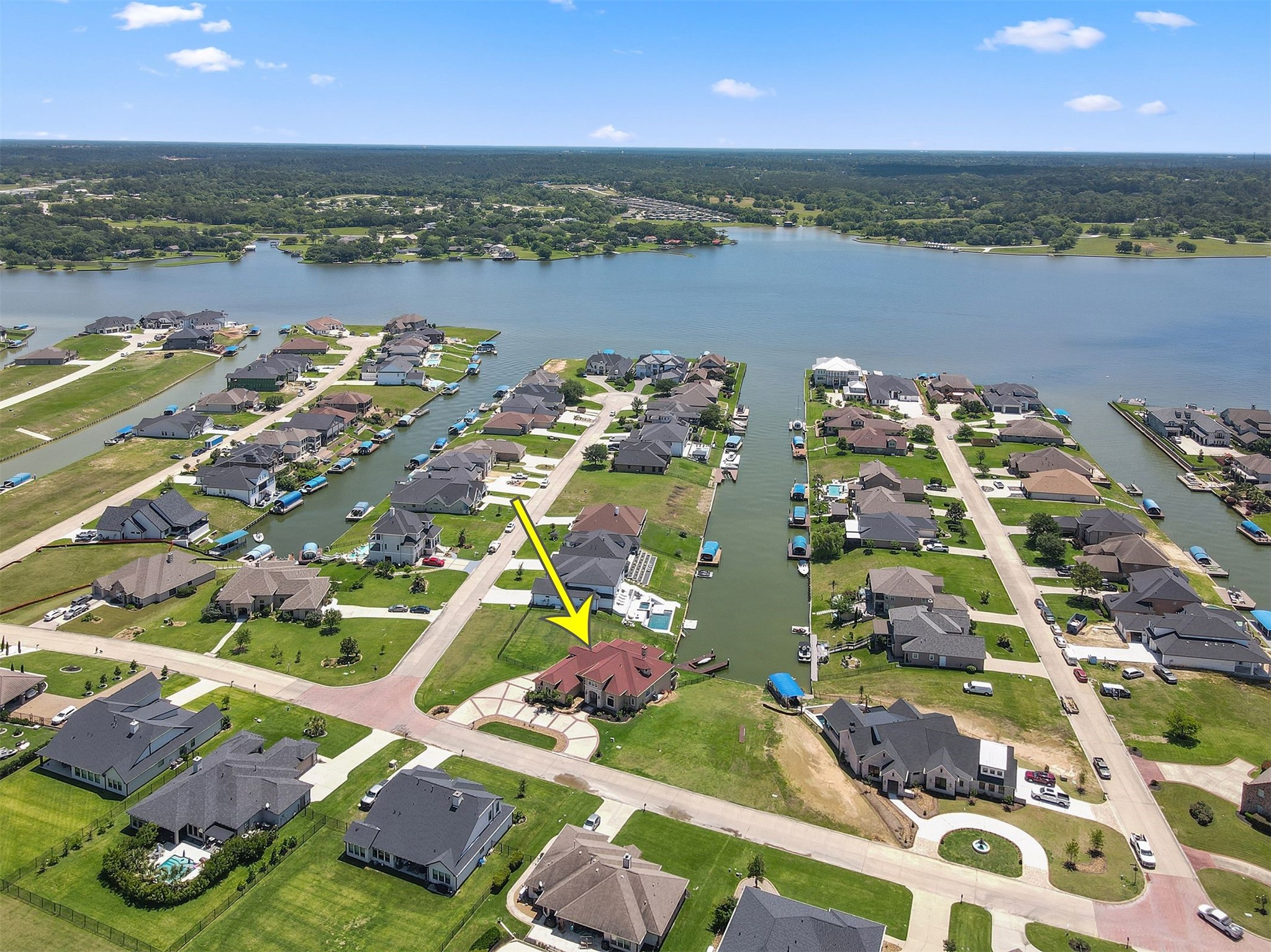 10896 Decatur Street Willis, TX 77318 - Photo 3 of 50 Discover serene lakeside living in this picturesque waterfront neighborhood, featuring a spacious, well-maintained home with lush green lawns, stunning water views, and easy access to recreational activities—ideal for a tranquil lifestyle.