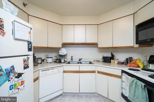 a kitchen with stainless steel appliances granite countertop a sink dishwasher stove and cabinets