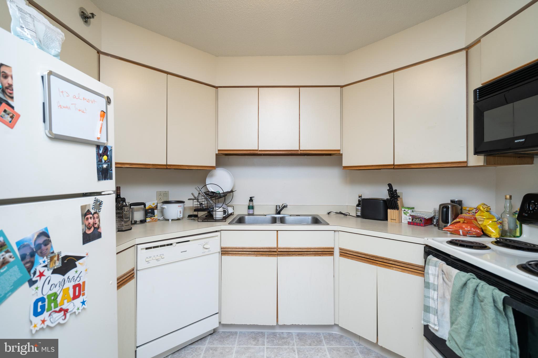 2020 Walnut Street, Unit 19K Philadelphia, PA 19103 - Photo 2 of 17 a kitchen with stainless steel appliances granite countertop a sink dishwasher stove and cabinets