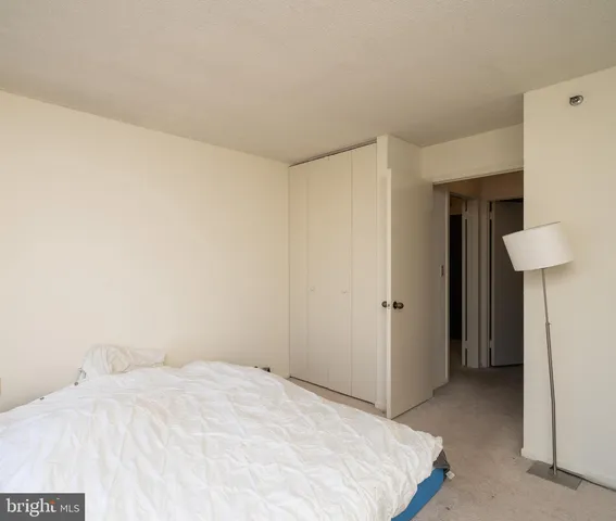 a bedroom with a bed and a table in it