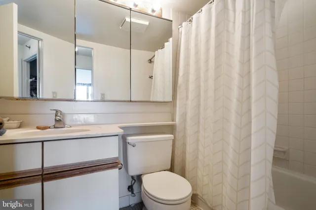 a bathroom with a toilet a sink and a mirror