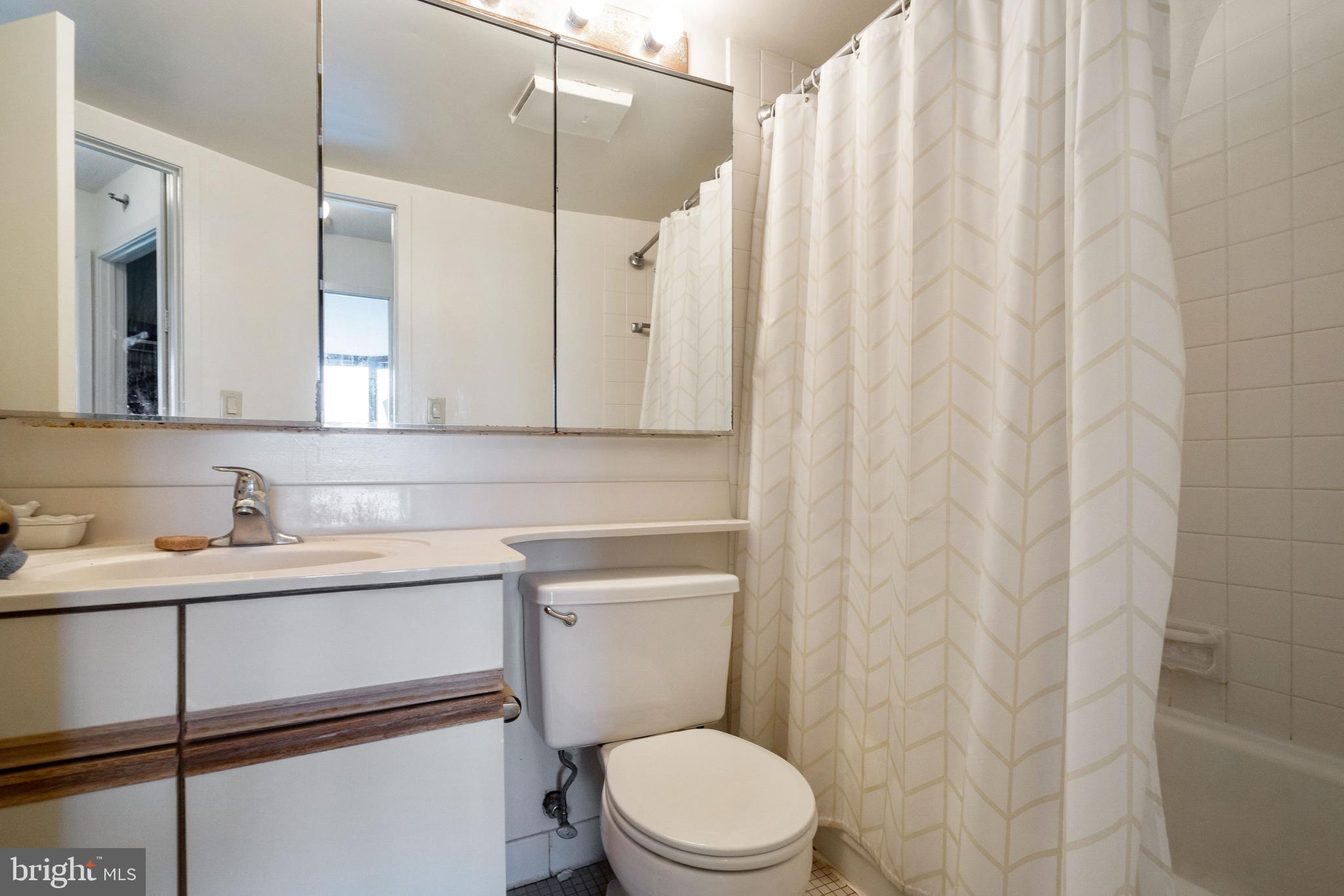 2020 Walnut Street, Unit 19K Philadelphia, PA 19103 - Photo 6 of 17 a bathroom with a toilet a sink and a mirror