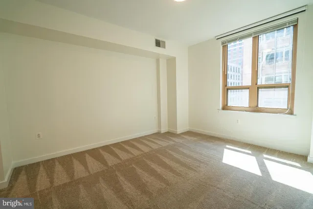 a view of an empty room with a window