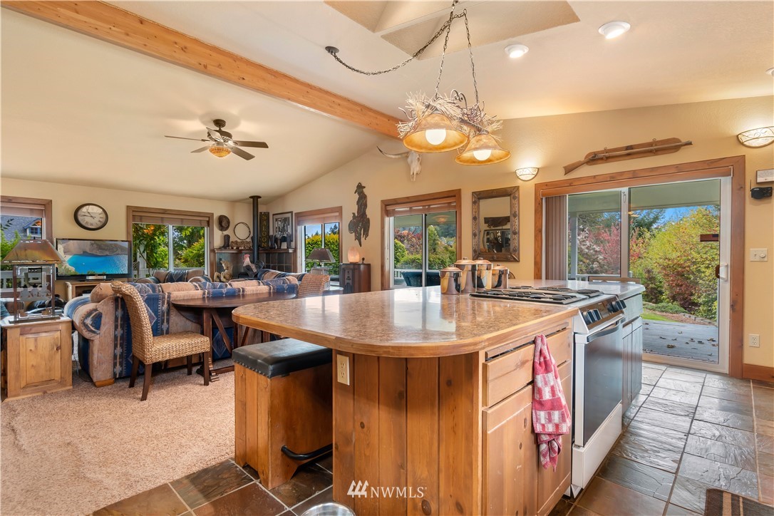 19334 Tall Firs Lane Southwest Rochester, WA 98579 - Photo 17 of 40 a view of a kitchen with furniture and a chandelier