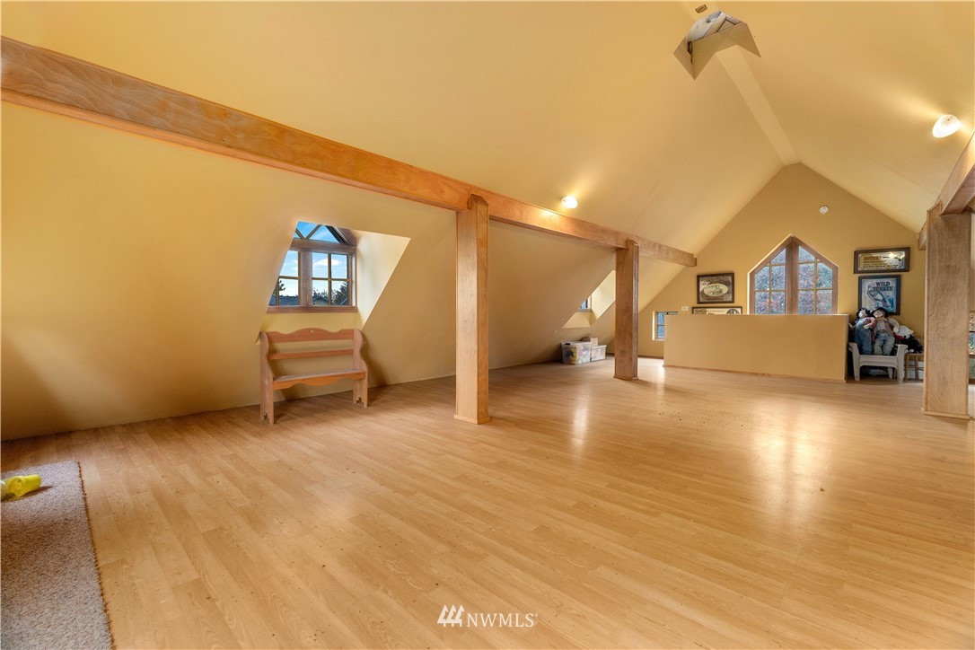 19334 Tall Firs Lane Southwest Rochester, WA 98579 - Photo 35 of 40 a view of a room with wooden floor and chair