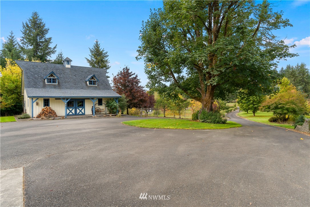 19334 Tall Firs Lane Southwest Rochester, WA 98579 - Photo 5 of 40 a view of a house with a small yard and a large tree