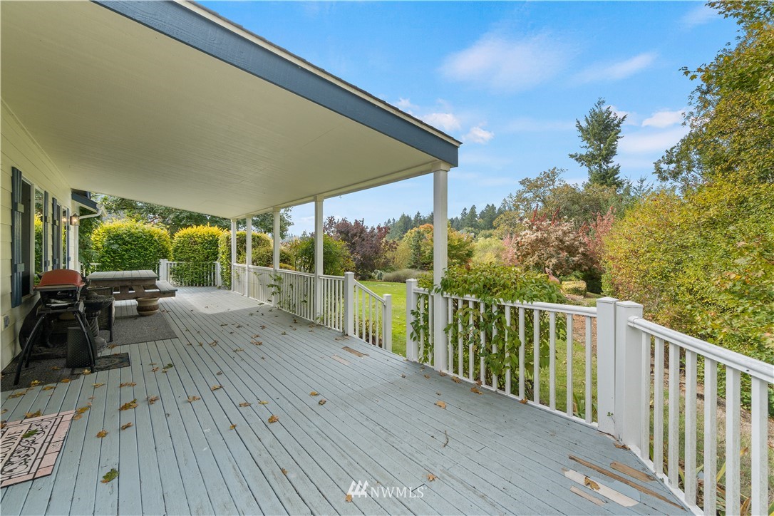 19334 Tall Firs Lane Southwest Rochester, WA 98579 - Photo 9 of 40 a view of a deck with wooden floor and seating space