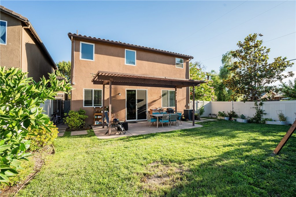 a view of a house with backyard porch and sitting area