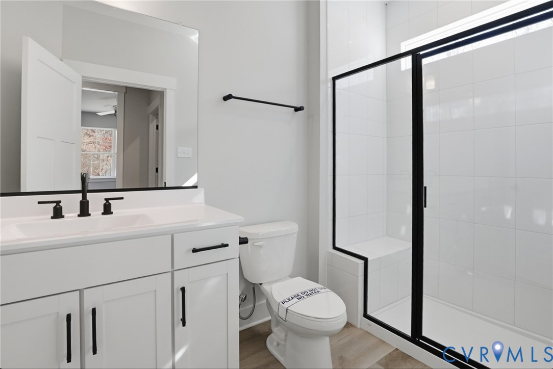 12420 Coalboro Road Chesterfield, VA 23838 - Photo 15 of 19 a bathroom with a toilet a sink and a mirror