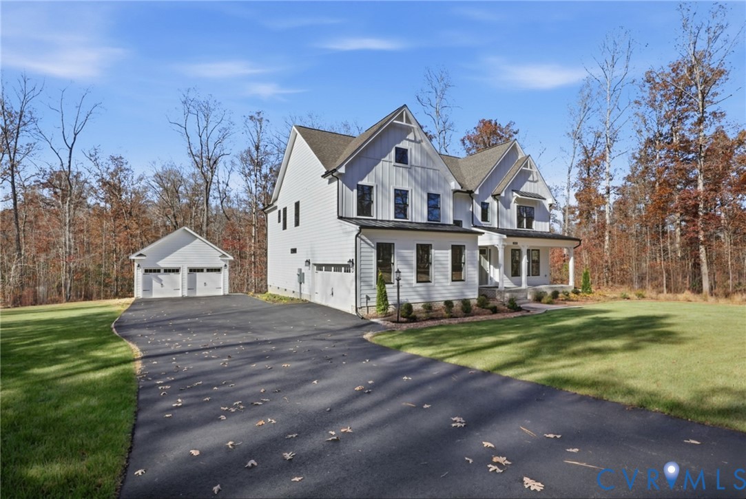 12420 Coalboro Road Chesterfield, VA 23838 - Photo 17 of 19 a front view of a house with a yard table and chairs