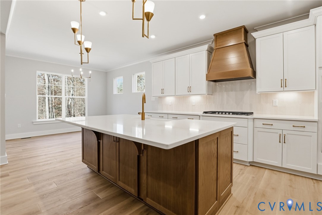 12420 Coalboro Road Chesterfield, VA 23838 - Photo 3 of 19 a kitchen with kitchen island granite countertop a sink cabinets and wooden floor