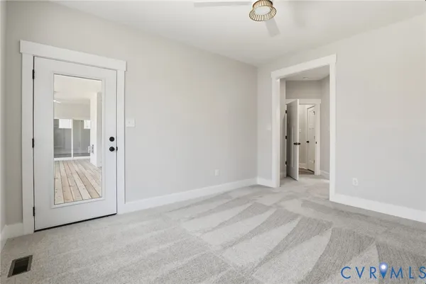 a view of an empty room with wooden door