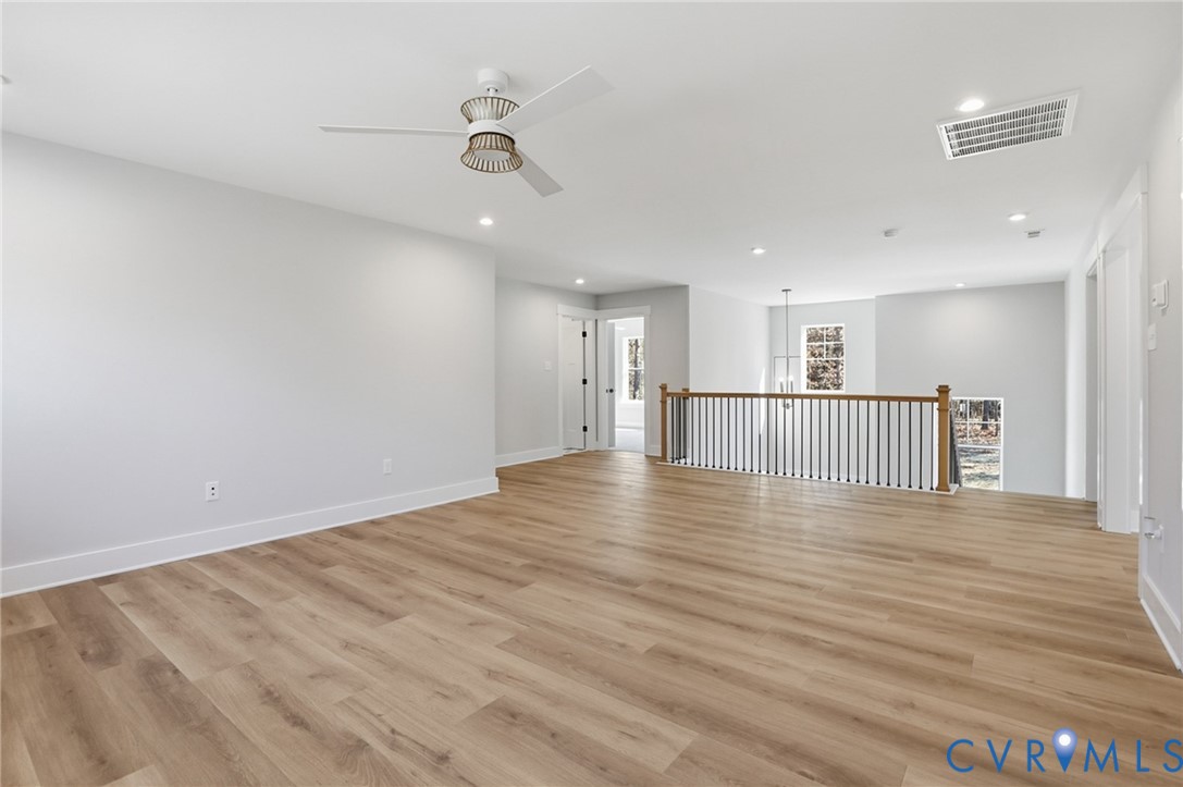 12420 Coalboro Road Chesterfield, VA 23838 - Photo 10 of 19 a view of a kitchen with a wooden floor and a ceiling fan