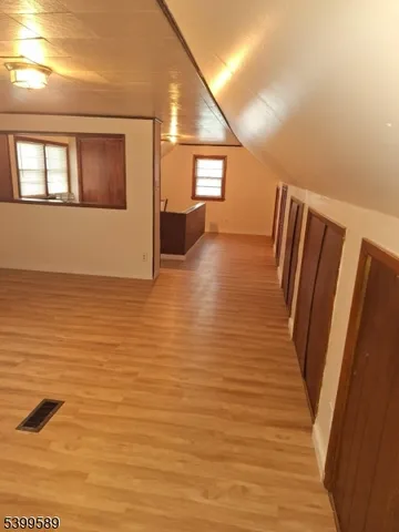 a view of a room with wooden floor and staircase
