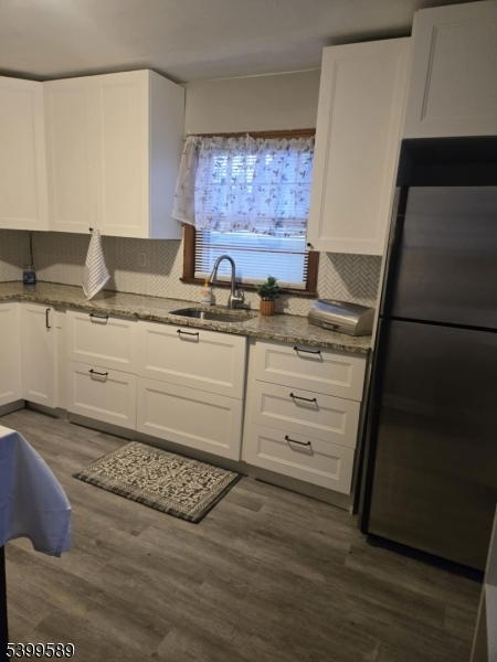 502 Drake Avenue Roselle, NJ 07203 - Photo 7 of 21 a kitchen with stainless steel appliances granite countertop a sink and a stove