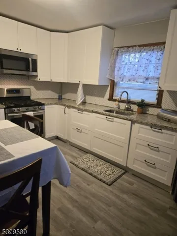 a kitchen with a sink stove and cabinets