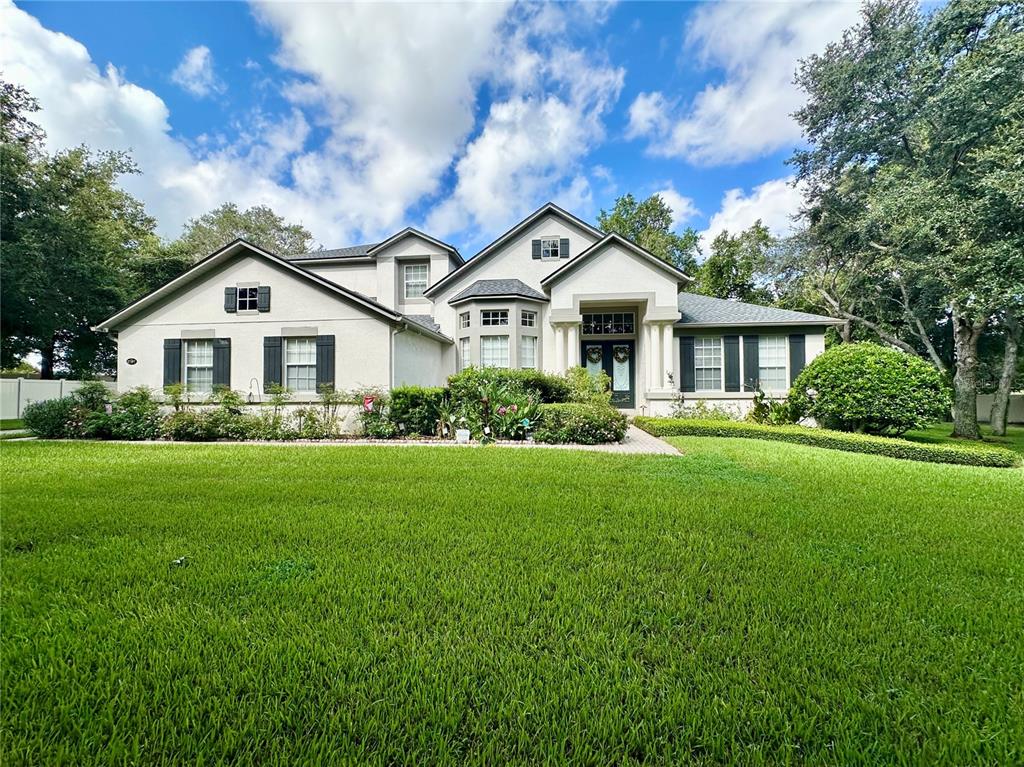 a front view of a house with a garden