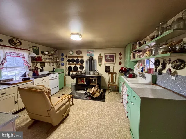 a living room with lots of furniture and clutter