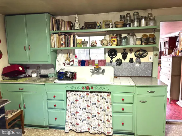a kitchen with a cabinets and a wooden floor