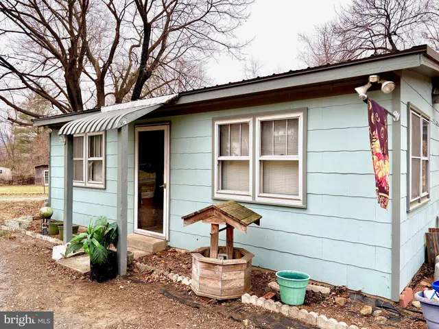 a front view of a house with sitting area
