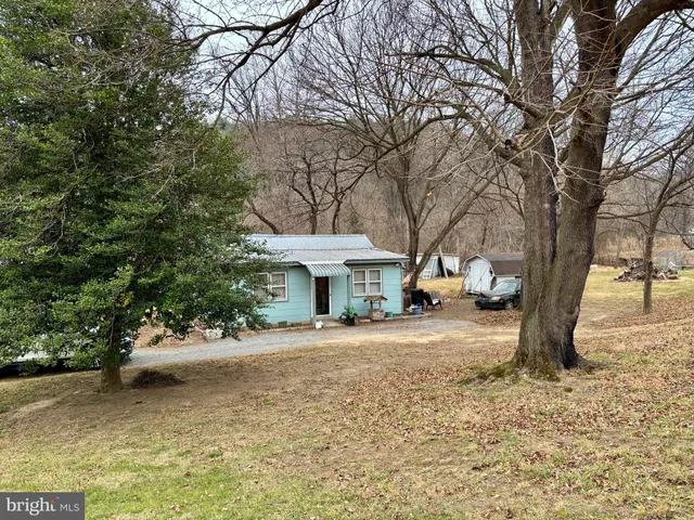 a view of a house with a yard covered in snow