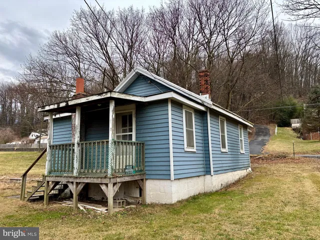 a backyard of a house with yard outdoor seating and barbeque oven