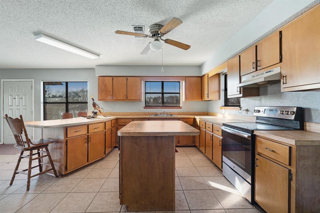 109 Private Road Brookston, TX 75421 - Photo 19 of 26 a kitchen with a sink stove and cabinets