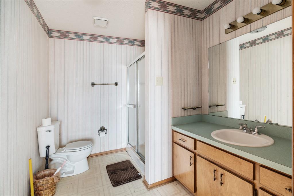109 Private Road Brookston, TX 75421 - Photo 23 of 26 a bathroom with a sink a toilet a mirror and shower
