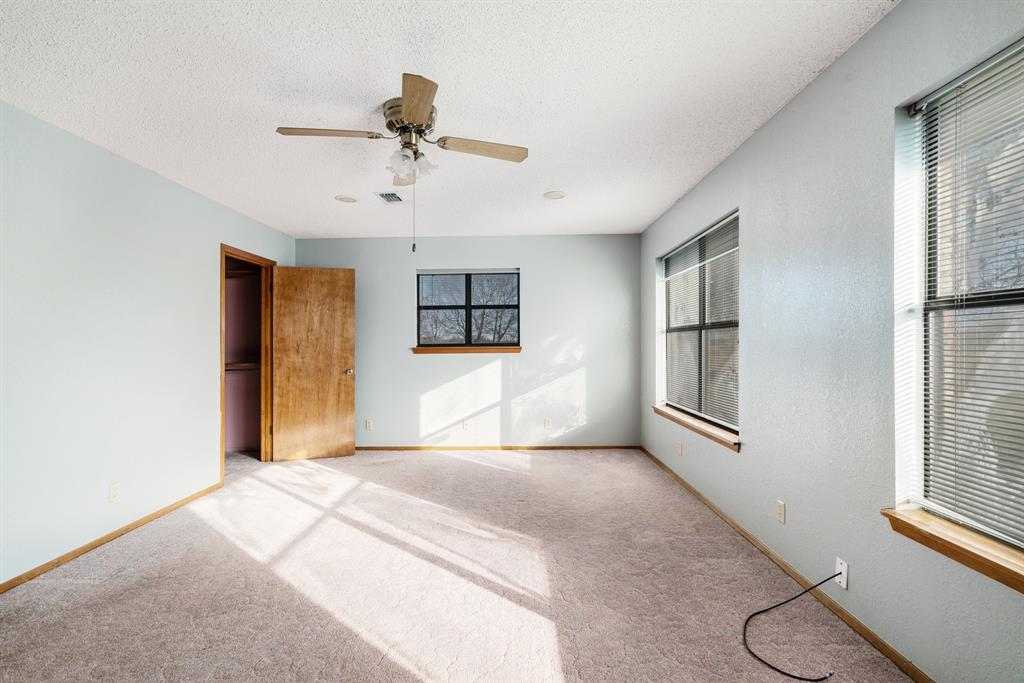 109 Private Road Brookston, TX 75421 - Photo 25 of 26 a bedroom with a bed and a chandelier