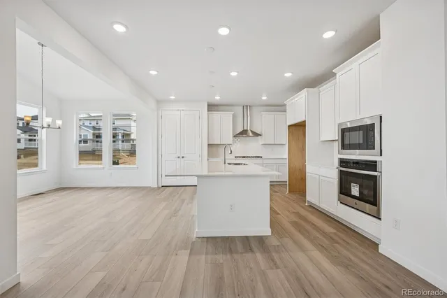 a view of kitchen with stainless steel appliances refrigerator oven and stove