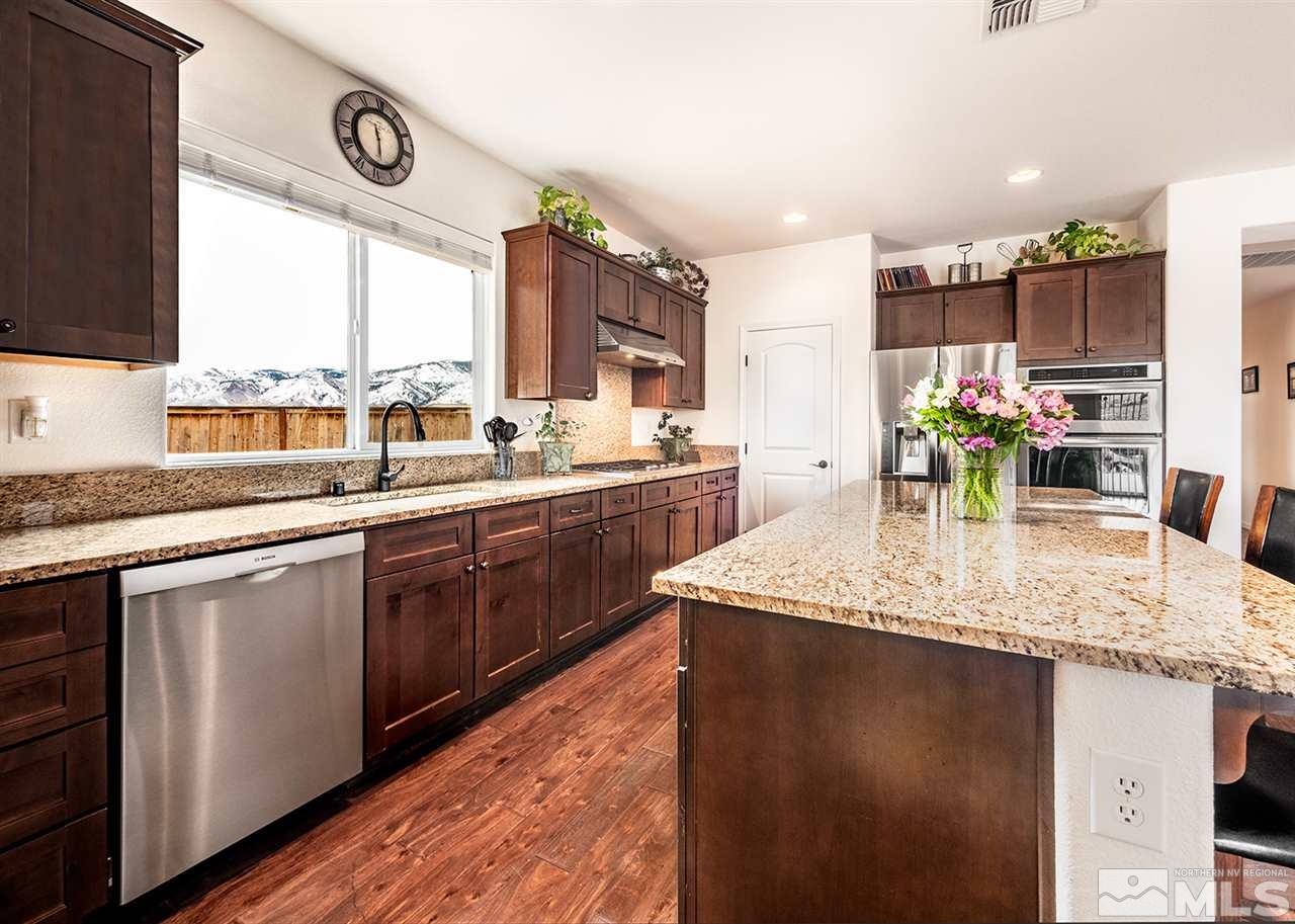 1640 Elk Run Trail Reno, NV 89523 - Photo 19 of 40 a kitchen with stainless steel appliances granite countertop a sink a counter space and a window