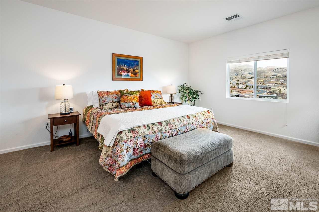 1640 Elk Run Trail Reno, NV 89523 - Photo 24 of 40 a bedroom with a bed lamp and a large window