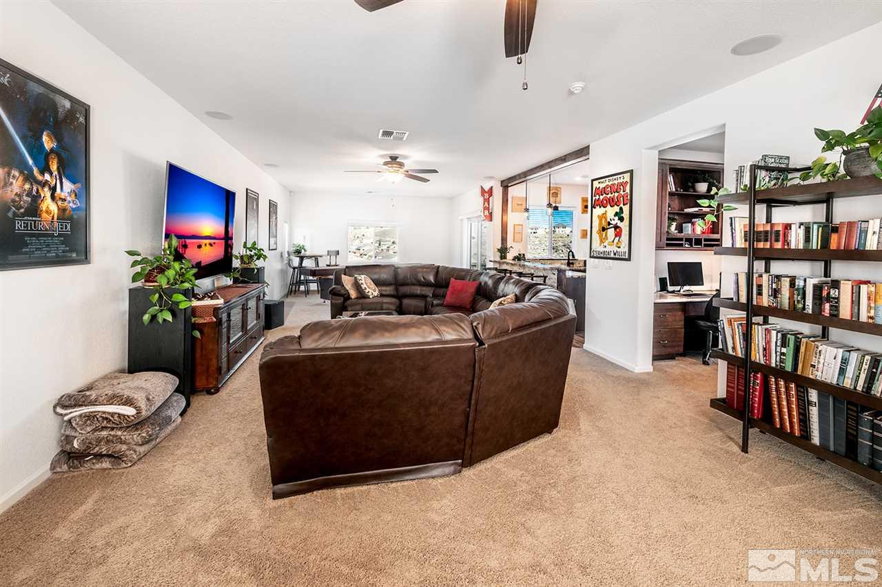 1640 Elk Run Trail Reno, NV 89523 - Photo 27 of 40 a living room with furniture lots of books and a large window