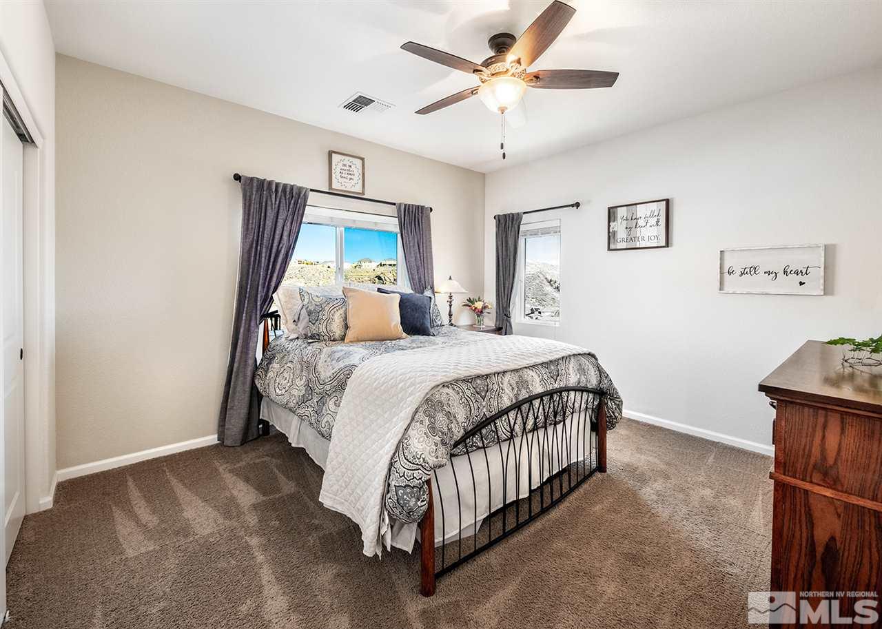 1640 Elk Run Trail Reno, NV 89523 - Photo 30 of 40 a bedroom with a large bed and a chandelier