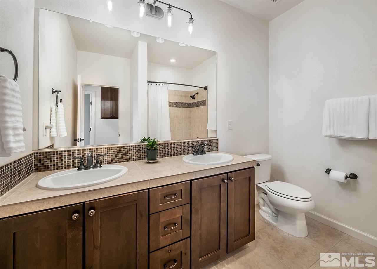 1640 Elk Run Trail Reno, NV 89523 - Photo 33 of 40 a bathroom with a granite countertop toilet sink and mirror