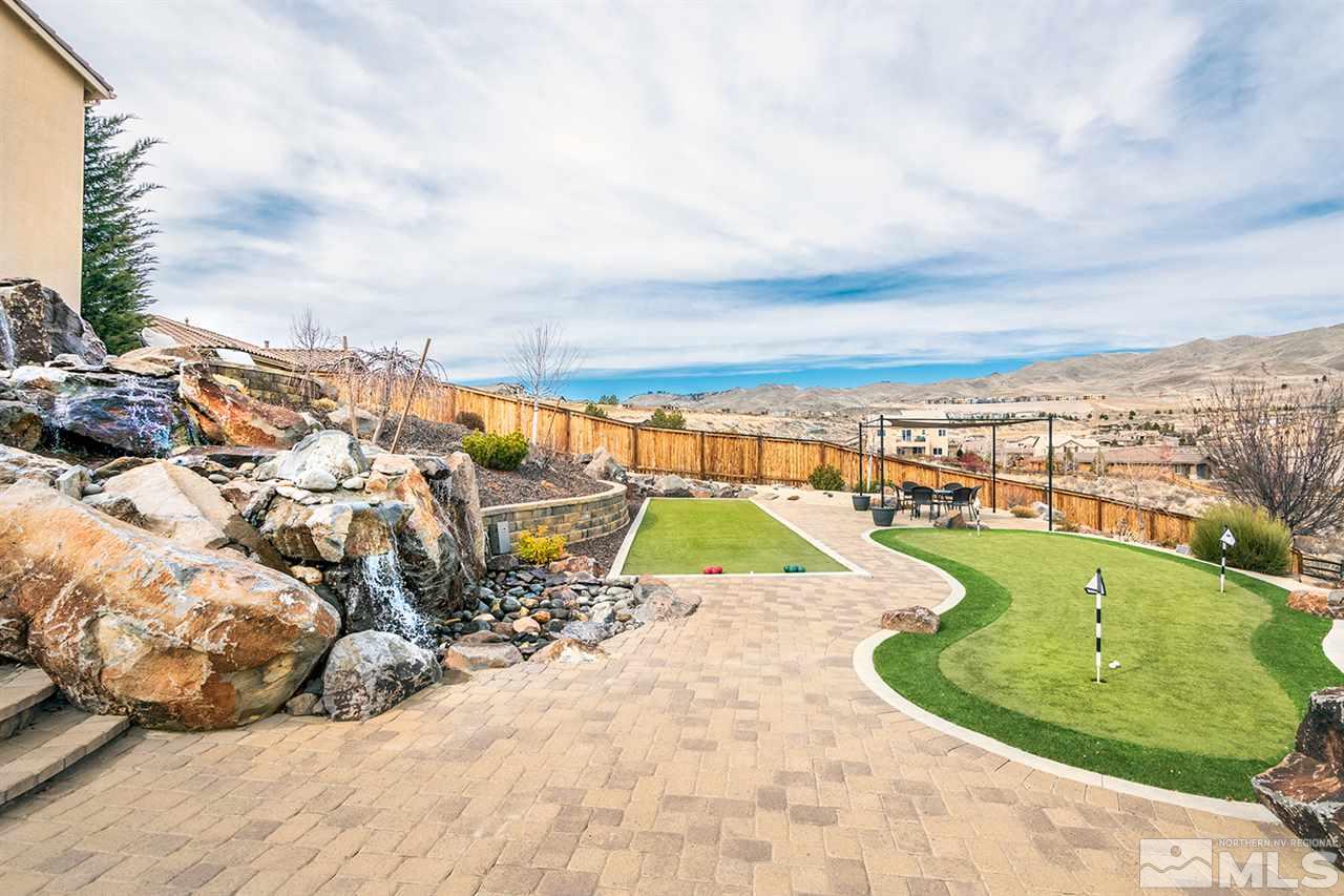 1640 Elk Run Trail Reno, NV 89523 - Photo 4 of 40 a view of a swimming pool with a lawn chairs