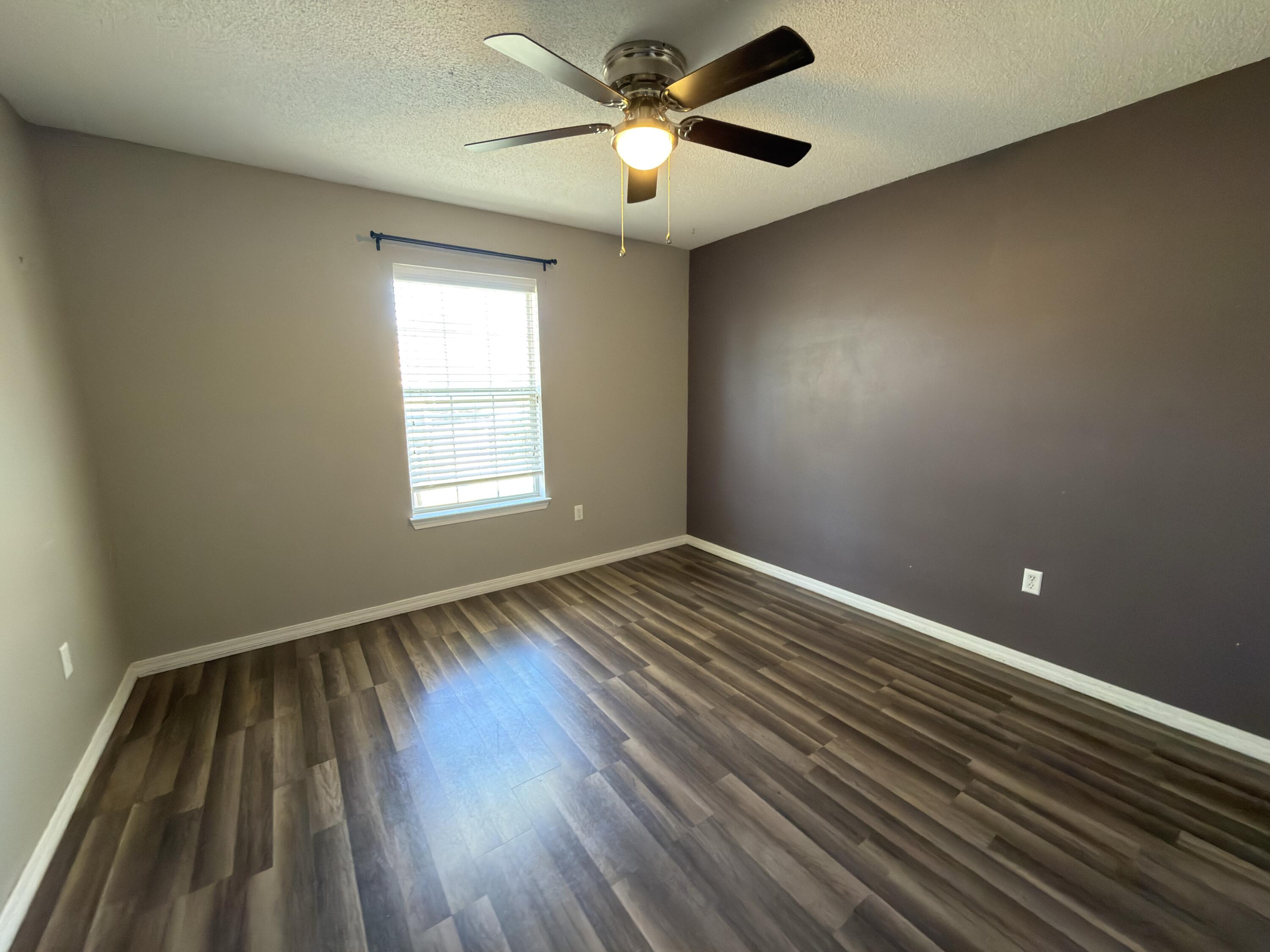 2673 Paddock Circle Crestview, FL 32536 - Photo 18 of 26 a view of empty room with wooden floor and fan