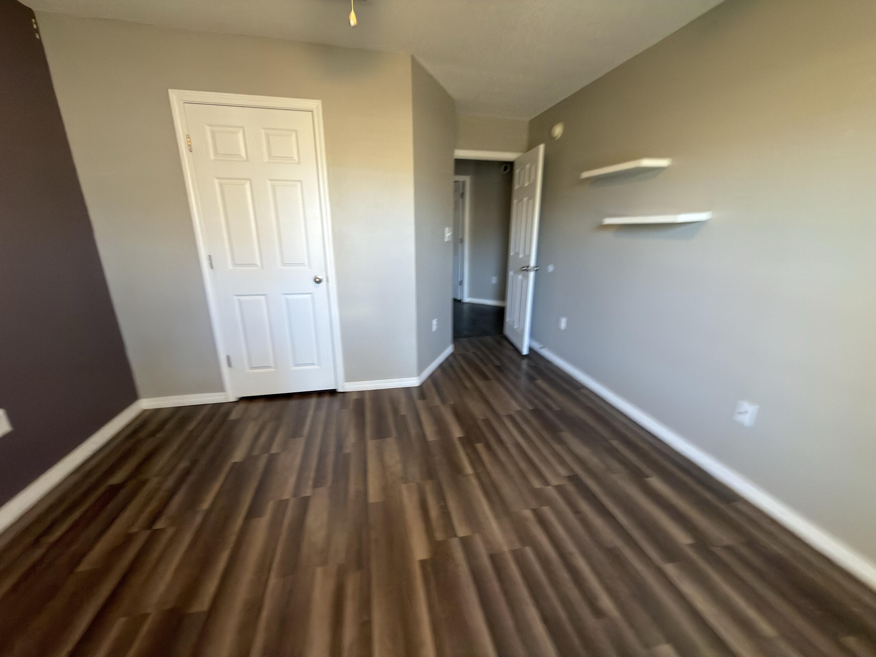 2673 Paddock Circle Crestview, FL 32536 - Photo 19 of 26 a view of an empty room with wooden floor and a window