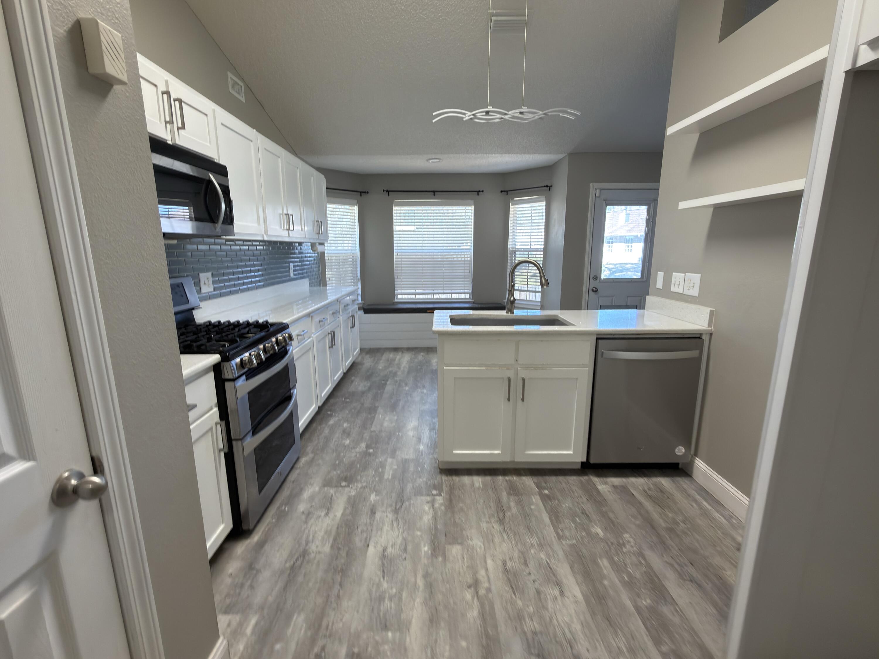 2673 Paddock Circle Crestview, FL 32536 - Photo 2 of 26 a large kitchen with stainless steel appliances granite countertop a stove and a sink