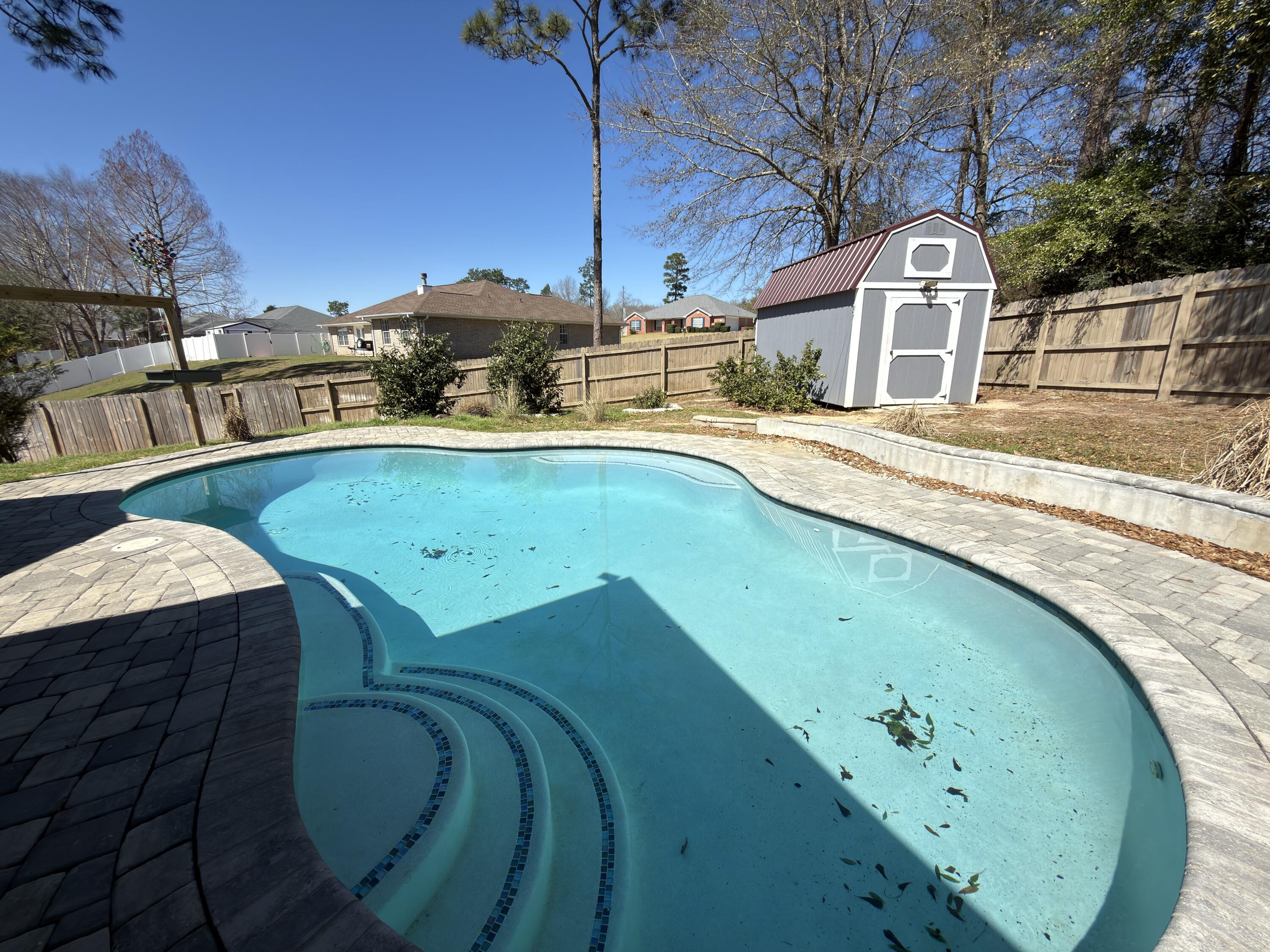 2673 Paddock Circle Crestview, FL 32536 - Photo 21 of 26 a view of a swimming pool with a lake