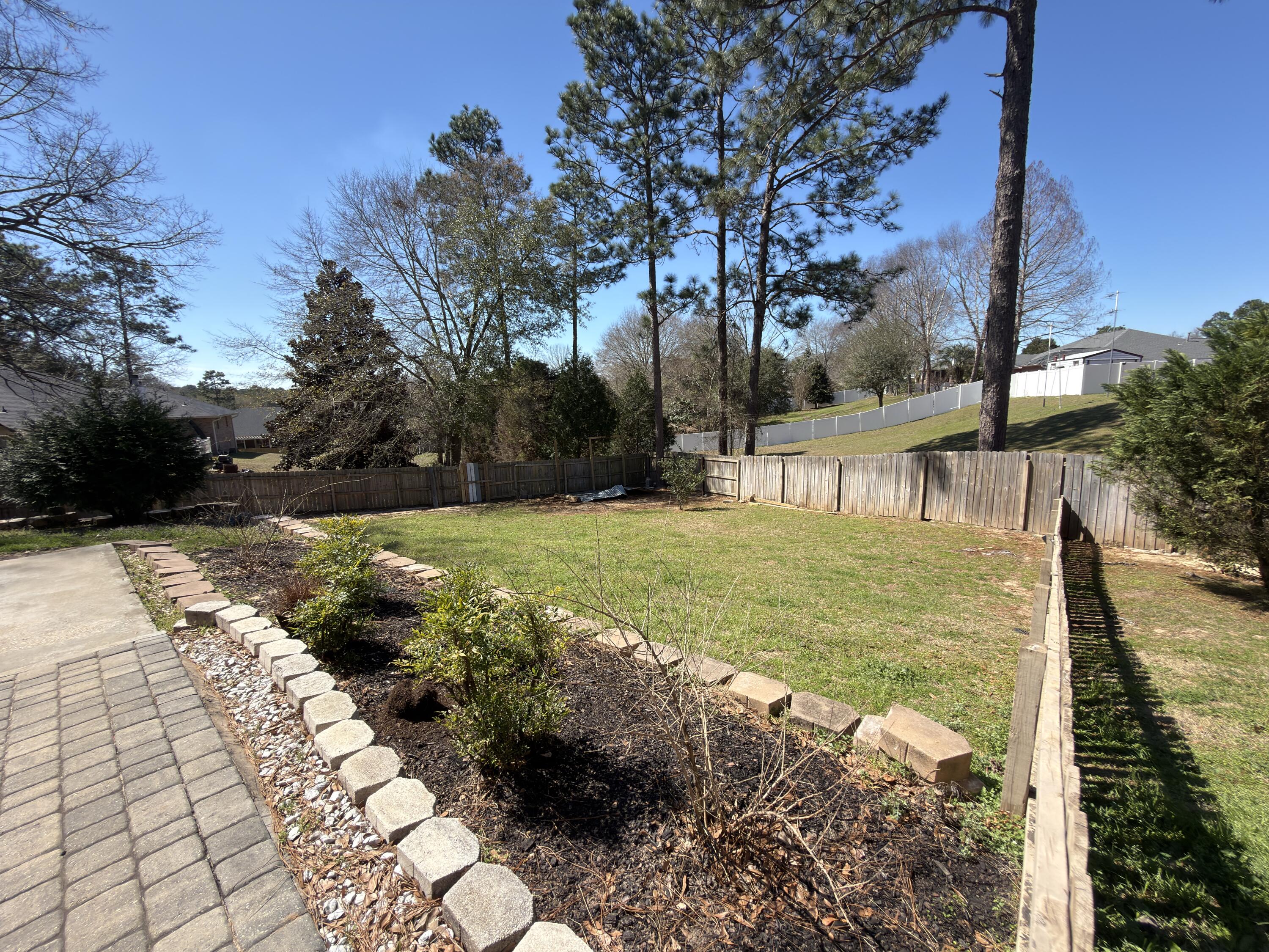 2673 Paddock Circle Crestview, FL 32536 - Photo 22 of 26 a view of a garden with an outdoor space