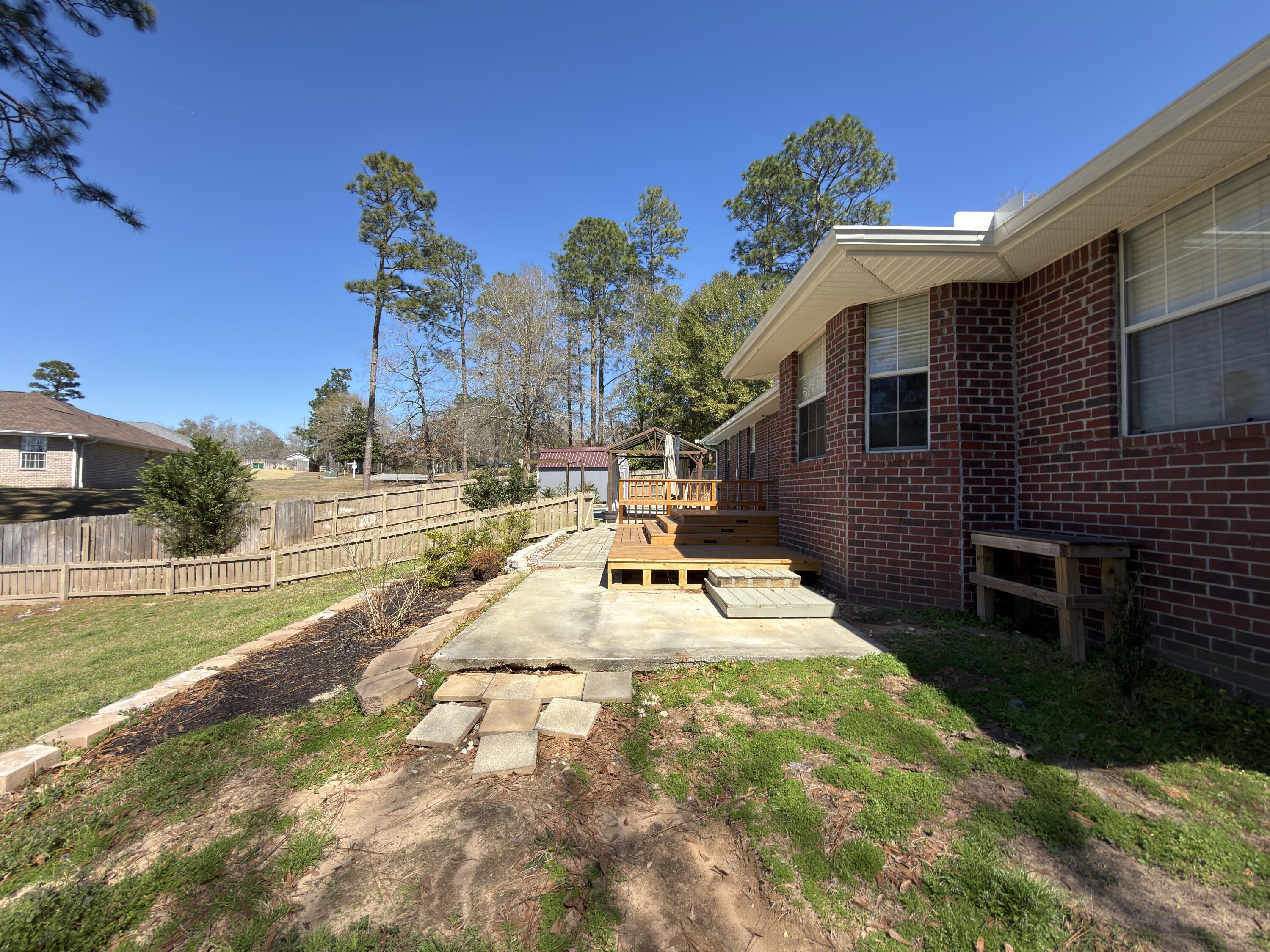 2673 Paddock Circle Crestview, FL 32536 - Photo 26 of 26 a view of a backyard with a garden and entertaining space