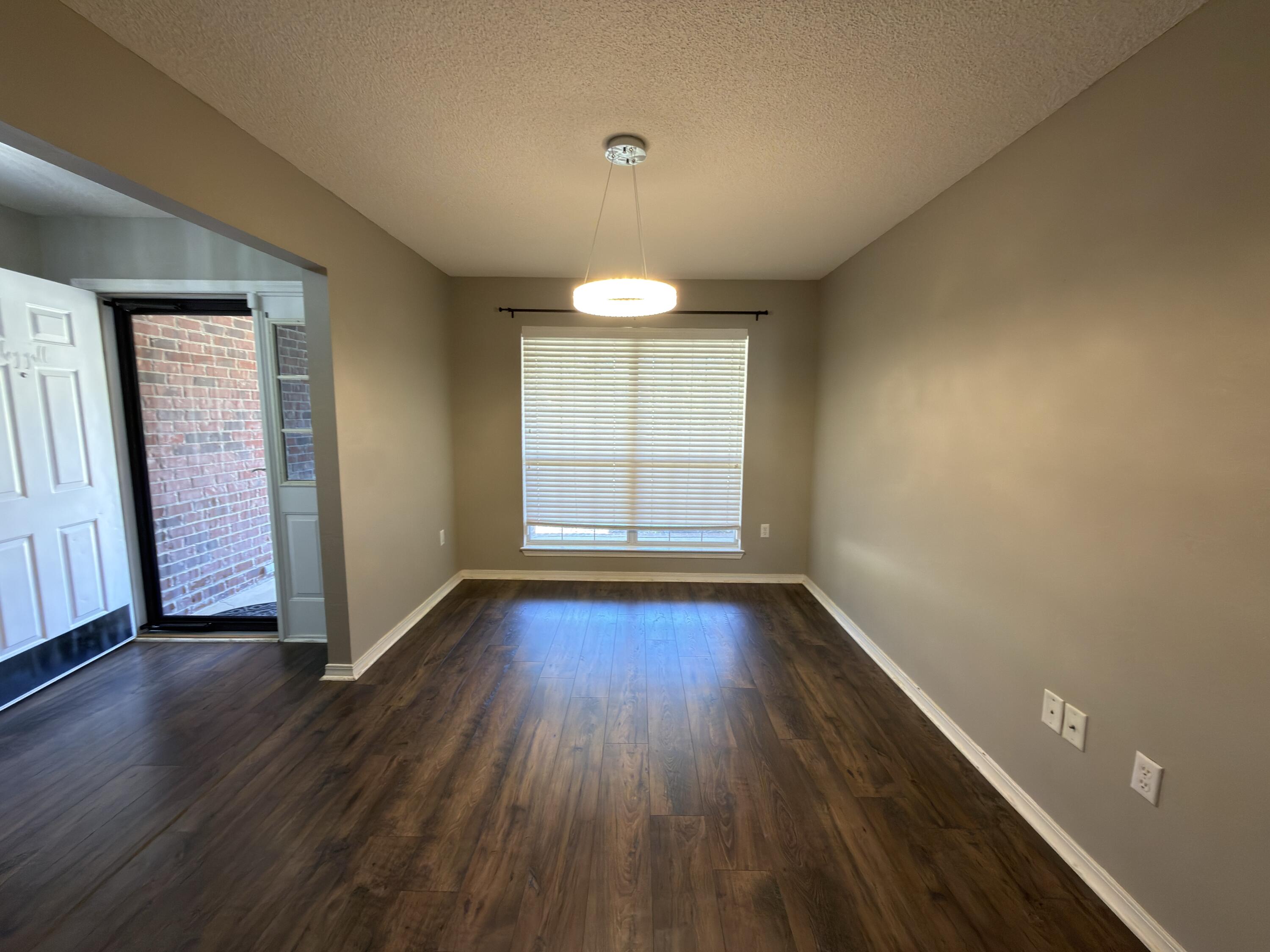 2673 Paddock Circle Crestview, FL 32536 - Photo 5 of 26 an empty room with wooden floor and windows