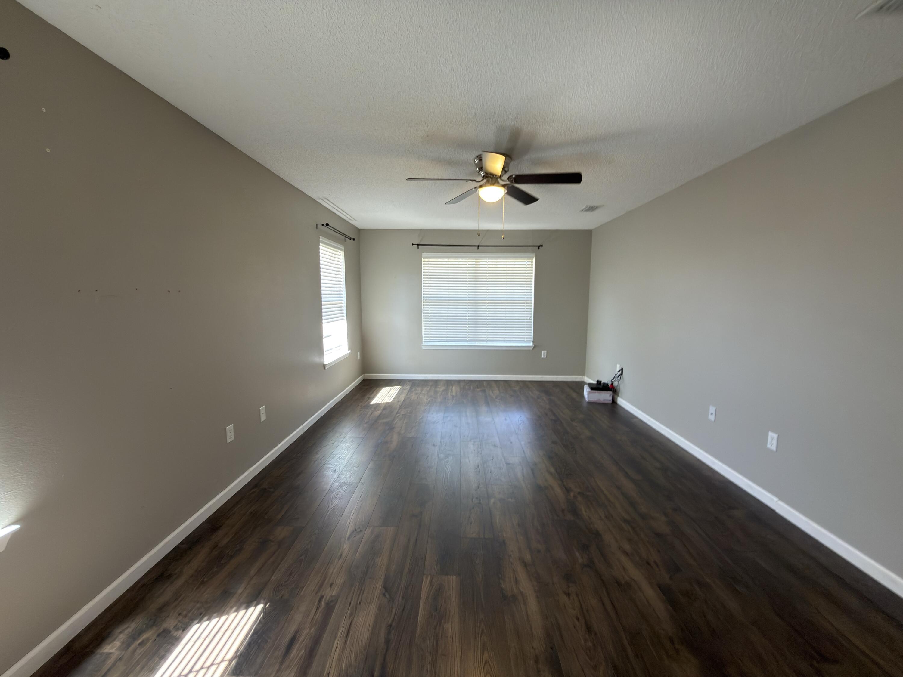 2673 Paddock Circle Crestview, FL 32536 - Photo 7 of 26 a view of empty room with wooden floor and fan