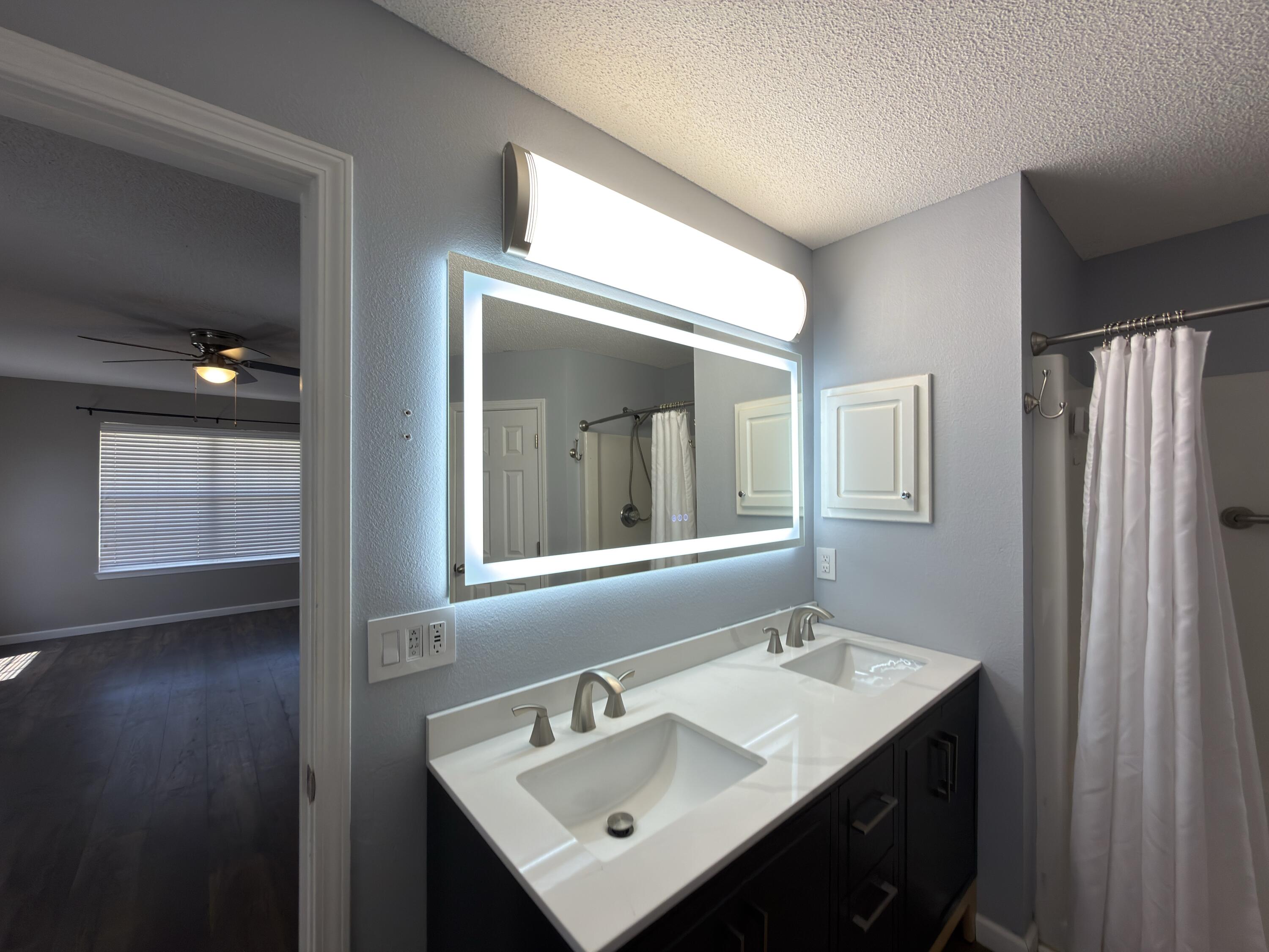 2673 Paddock Circle Crestview, FL 32536 - Photo 9 of 26 a bathroom with a sink mirror and vanity