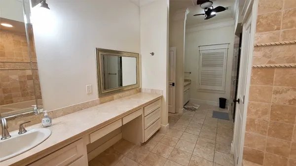 a spacious bathroom with a granite countertop sink mirror and shower