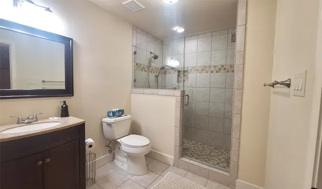 a bathroom with a toilet a sink and shower