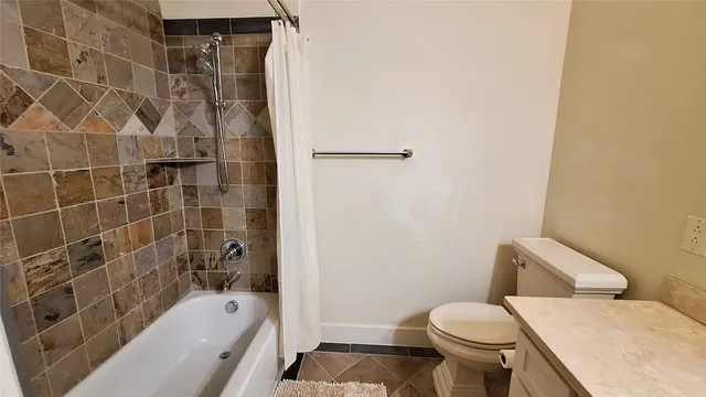 a bathroom with a toilet and shower